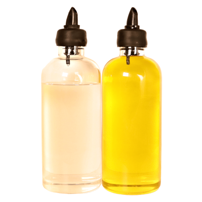 2 glass bottles, each 500ml, containing oil, with spouts for pouring. Use for pantry or display in kitchen